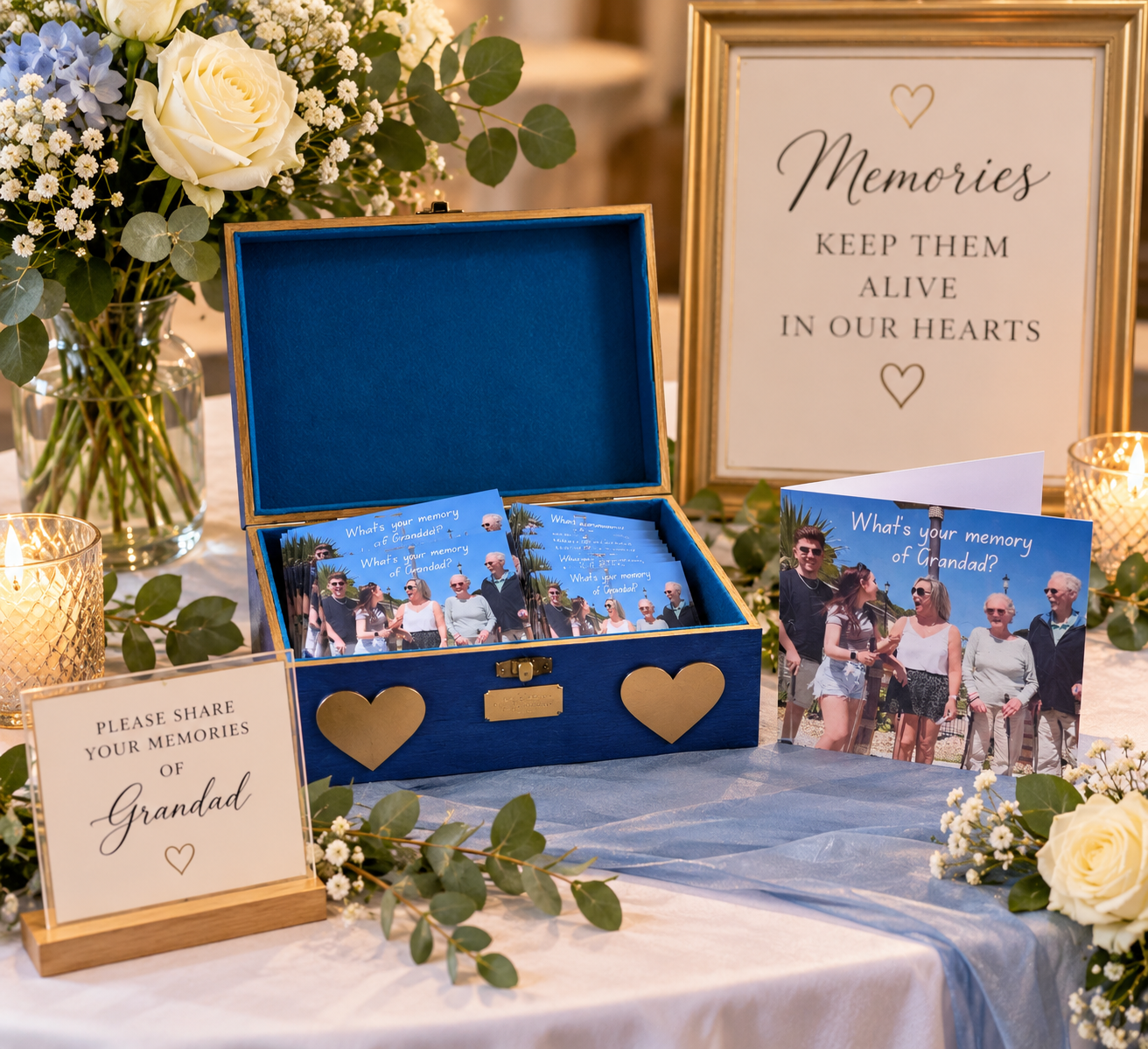 Blue keepsake box open with photos, surrounded by flowers, candles, and framed “Memories” message for Grandad.